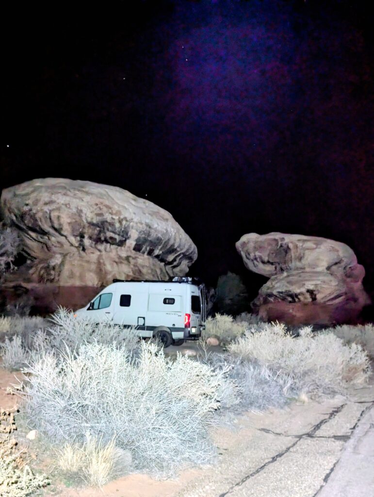 Van parked by two large rocks